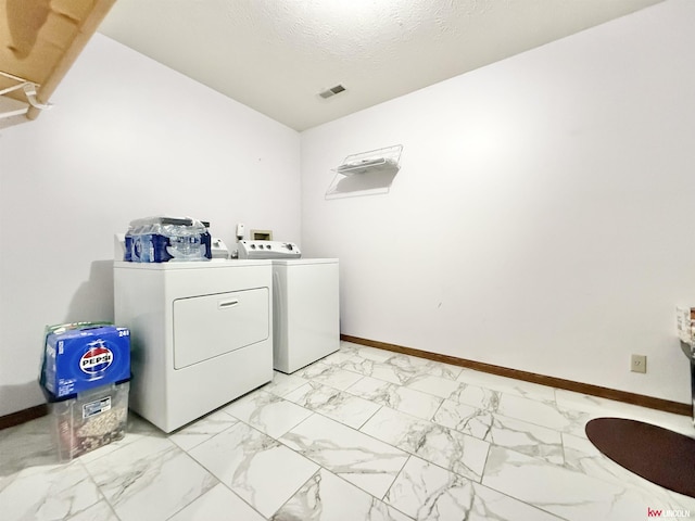 724 W Belmont Ave, Lincoln, NE 68521 - laundry room featuring washing machine and dryer and light marble finish floors