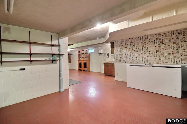 414 N Myers St, Fremont, NE 68025 - finished below grade area featuring refrigerator, concrete block wall, and tile patterned floors