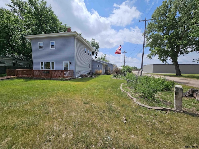 607 4th St, Edgar, NE 68935 - view of side of home featuring a lawn, a chimney, and a wooden deck