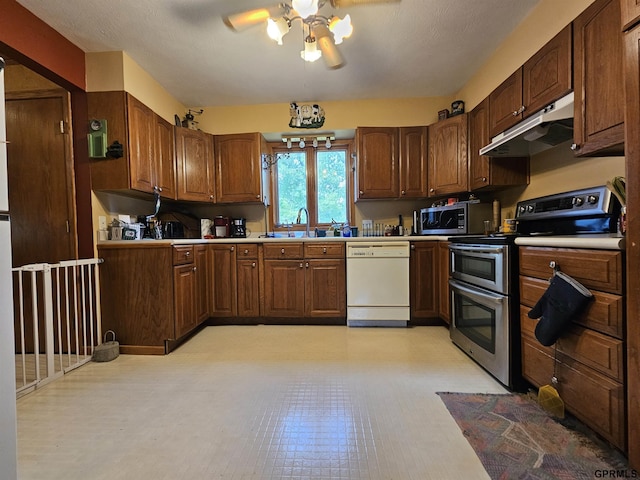 607 4th St, Edgar, NE 68935 - kitchen with appliances with stainless steel finishes, under cabinet range hood, ceiling fan, light countertops, and light flooring