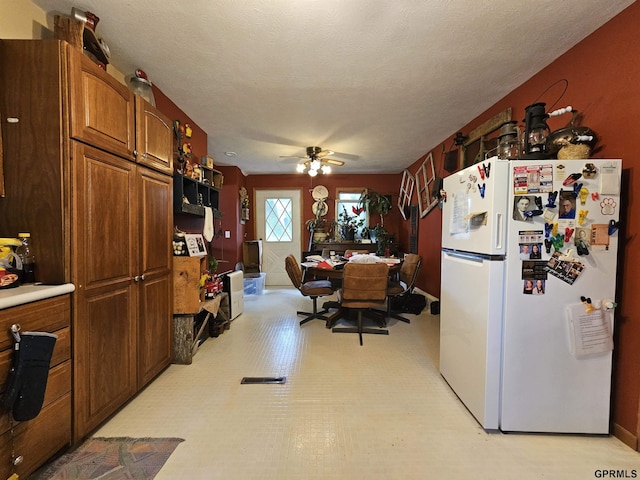607 4th St, Edgar, NE 68935 - kitchen with freestanding refrigerator, brown cabinets, light countertops, and a ceiling fan