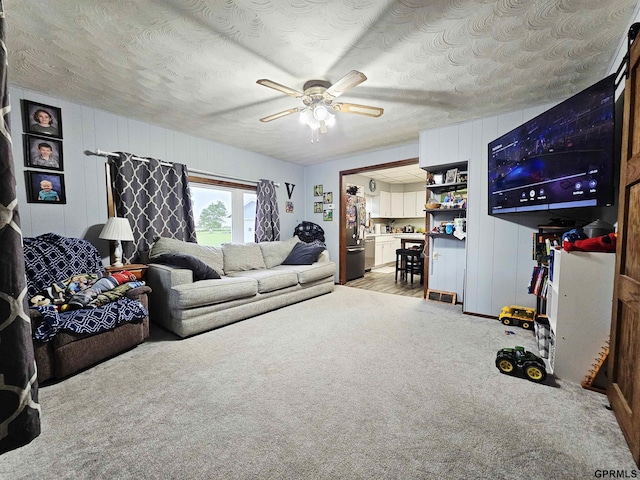 401 Chestnut Ave, Saronville, NE 68975 - living room with ceiling fan, light carpet, and a textured ceiling
