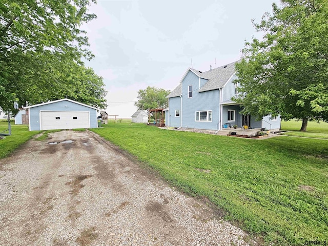 401 Chestnut Ave, Saronville, NE 68975 - view of property exterior featuring a detached garage, an outbuilding, and a yard