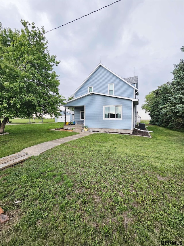 401 Chestnut Ave, Saronville, NE 68975 - view of side of property with a lawn and covered porch