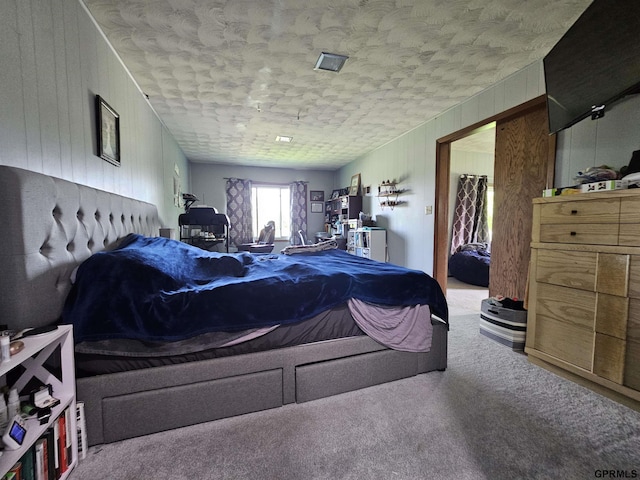 401 Chestnut Ave, Saronville, NE 68975 - bedroom with carpet floors, a textured ceiling, and wood walls