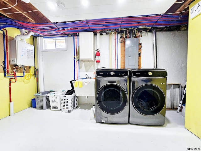 108 W Ridge St, Sutton, NE 68979 - laundry area featuring electric panel, washing machine and clothes dryer, and tankless water heater