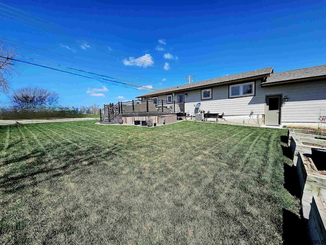 108 W Ridge St, Sutton, NE 68979 - rear view of house with a lawn, a wooden deck, and stairway