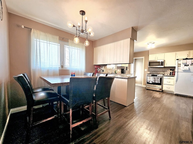 108 W Ridge St, Sutton, NE 68979 - dining area with dark wood finished floors and a chandelier