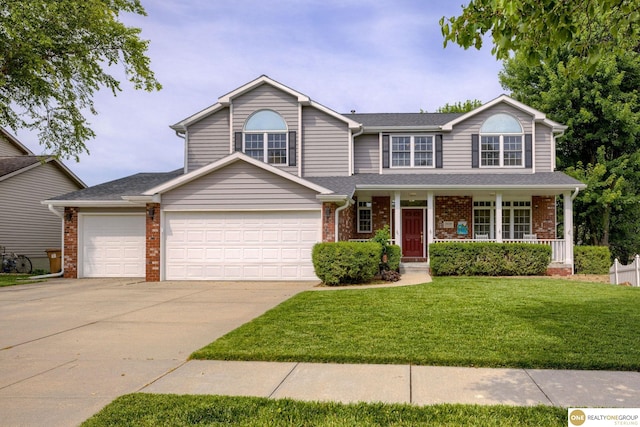 7409 Elk Creek Dr, Lincoln, NE 68516 - traditional-style home featuring concrete driveway, a porch, brick siding, a front lawn, and an attached garage
