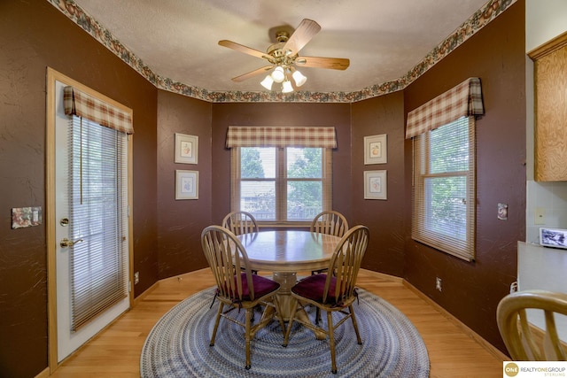 7409 Elk Creek Dr, Lincoln, NE 68516 - dining area featuring light wood-type flooring, a textured wall, and a ceiling fan