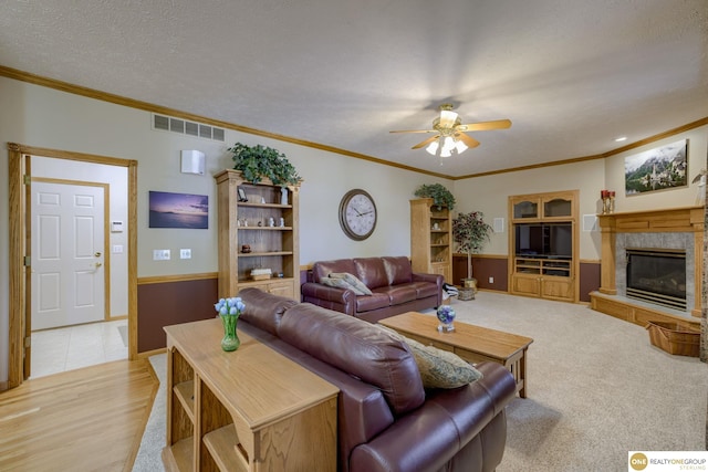 7409 Elk Creek Dr, Lincoln, NE 68516 - living room featuring a ceiling fan, ornamental molding, and a fireplace