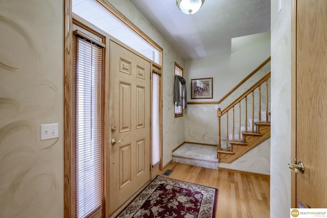 7409 Elk Creek Dr, Lincoln, NE 68516 - entryway with wood finished floors and stairs