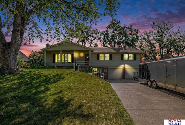 605 S 120th Ave, Omaha, NE 68154 - ranch-style house with a garage, driveway, a yard, and brick siding