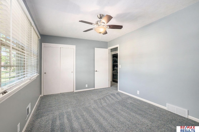 605 S 120th Ave, Omaha, NE 68154 - unfurnished bedroom featuring carpet, a closet, and ceiling fan