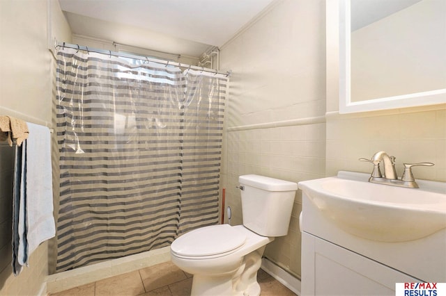 605 S 120th Ave, Omaha, NE 68154 - bathroom with tile walls, vanity, tiled shower, and tile patterned flooring