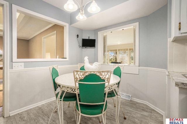 605 S 120th Ave, Omaha, NE 68154 - dining room with wainscoting and a chandelier