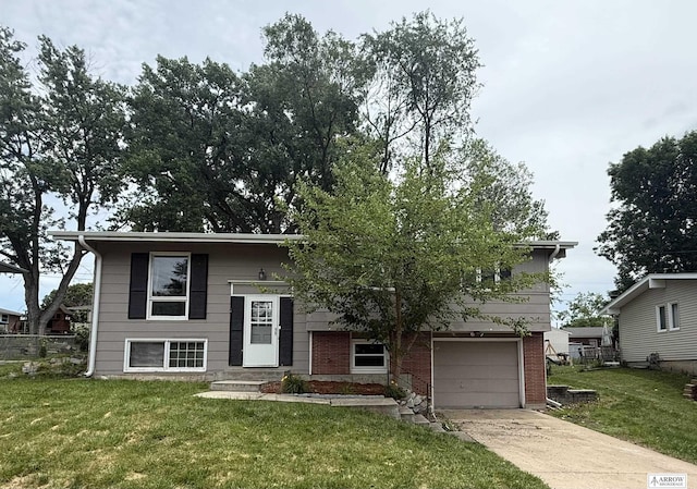 400 W Broadview St, Lincoln, NE 68505 - split foyer home featuring driveway, a front lawn, an attached garage, and brick siding