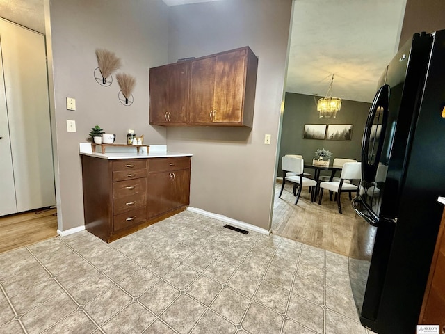 400 W Broadview St, Lincoln, NE 68505 - bathroom with a chandelier, tile patterned flooring, and vanity
