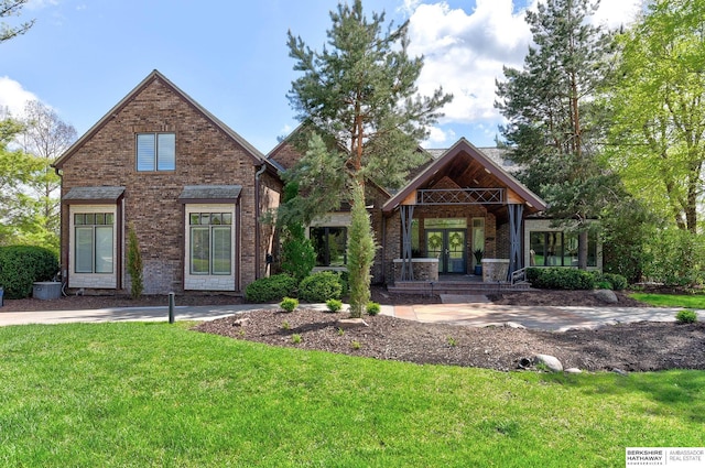 14341 Hamilton St, Omaha, NE 68154 - craftsman-style house featuring brick siding, a front lawn, and covered porch