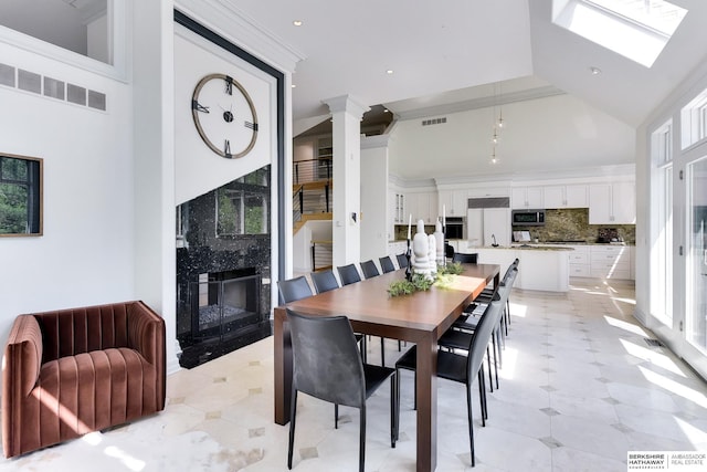 14341 Hamilton St, Omaha, NE 68154 - dining area with a premium fireplace, plenty of natural light, recessed lighting, decorative columns, and a high ceiling