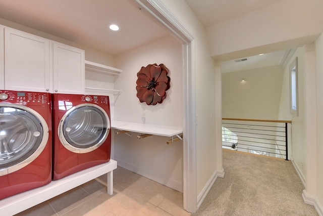 14341 Hamilton St, Omaha, NE 68154 - washroom featuring washer and clothes dryer, cabinet space, and light tile patterned floors