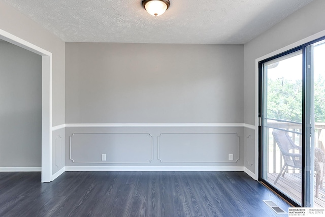 5023 N 96th St, Omaha, NE 68134 - unfurnished room with dark wood-style floors and a textured ceiling