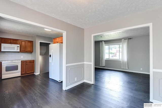 5023 N 96th St, Omaha, NE 68134 - kitchen featuring white appliances, dark wood-style floors, brown cabinetry, a textured ceiling, and light countertops
