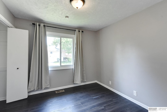 5023 N 96th St, Omaha, NE 68134 - empty room featuring a textured ceiling and dark wood-style floors