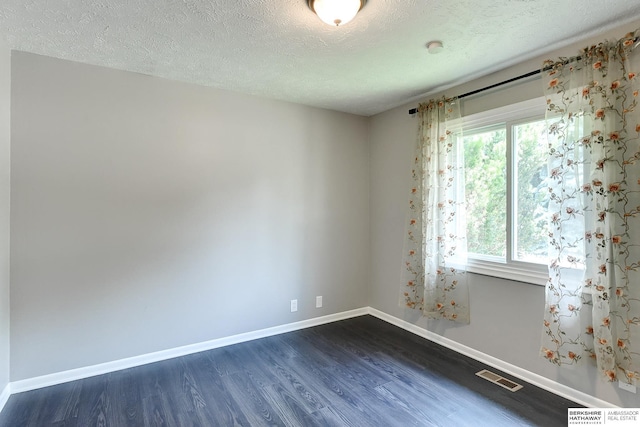 5023 N 96th St, Omaha, NE 68134 - empty room with dark wood-type flooring and a textured ceiling