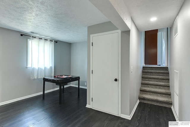 5023 N 96th St, Omaha, NE 68134 - playroom featuring dark wood finished floors and a textured ceiling