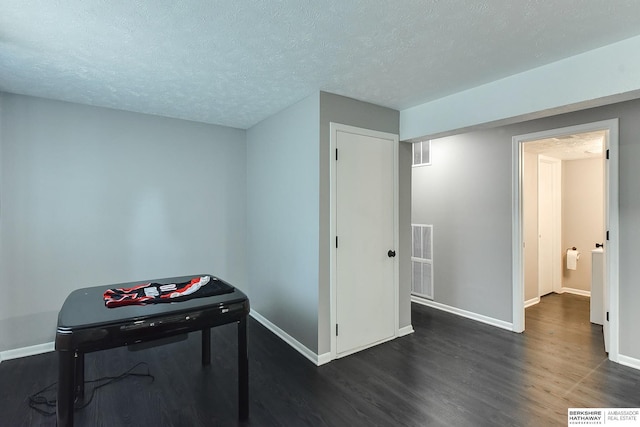 5023 N 96th St, Omaha, NE 68134 - playroom with dark wood-style floors and a textured ceiling