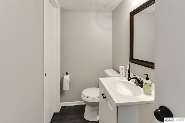 5023 N 96th St, Omaha, NE 68134 - half bath with vanity, a textured ceiling, and wood finished floors