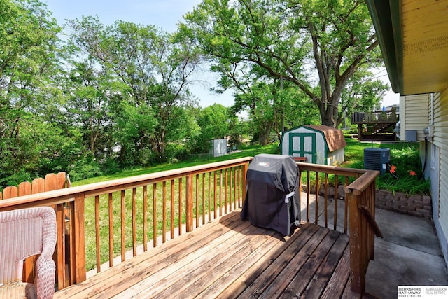 5023 N 96th St, Omaha, NE 68134 - wooden deck featuring a shed, grilling area, a yard, and view of wooded area