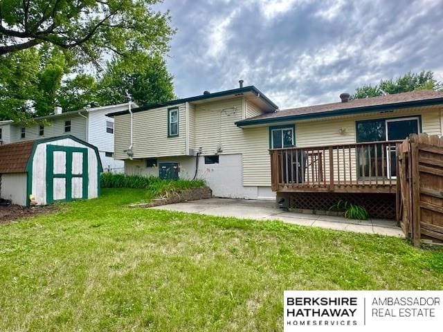 5023 N 96th St, Omaha, NE 68134 - rear view of house featuring a storage unit, a deck, and a lawn