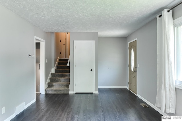 5023 N 96th St, Omaha, NE 68134 - entryway with a textured ceiling, dark wood-style floors, and stairway