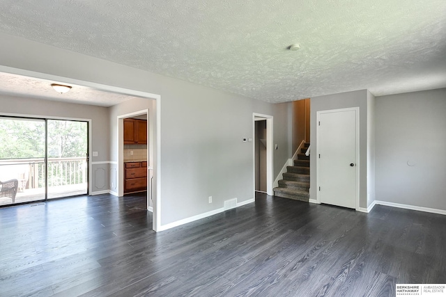 5023 N 96th St, Omaha, NE 68134 - empty room with a textured ceiling, dark wood-type flooring, and stairs