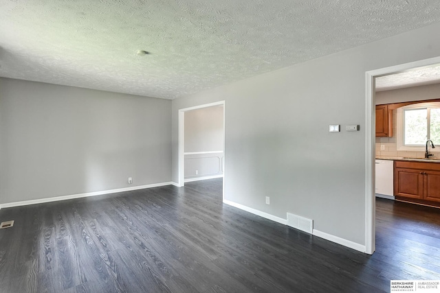 5023 N 96th St, Omaha, NE 68134 - spare room featuring dark wood finished floors and a textured ceiling