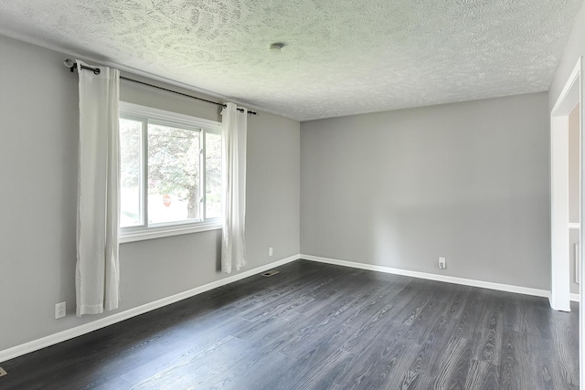 5023 N 96th St, Omaha, NE 68134 - unfurnished room with dark wood-style flooring and a textured ceiling