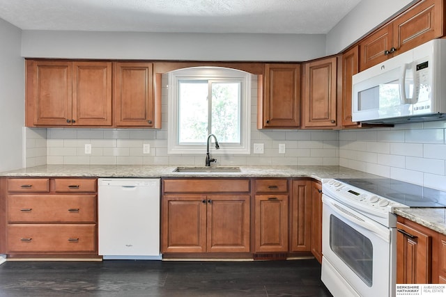 5023 N 96th St, Omaha, NE 68134 - kitchen with white appliances, brown cabinetry, dark wood-style floors, and backsplash