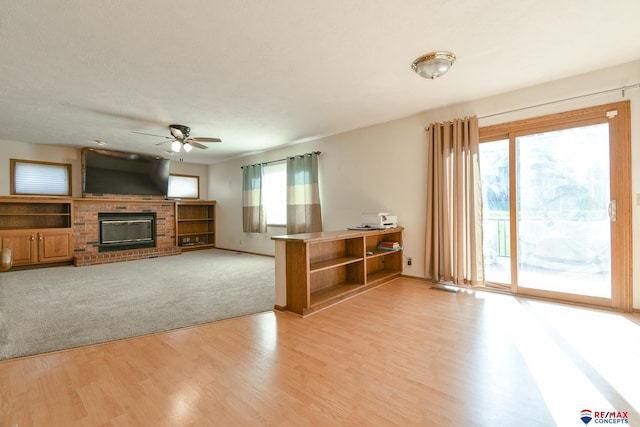 3646 S 77th St, Lincoln, NE 68506 - living area with a ceiling fan, a fireplace, and light wood-type flooring