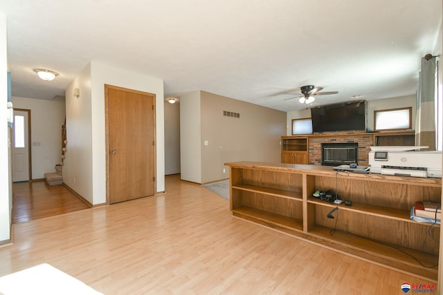 3646 S 77th St, Lincoln, NE 68506 - living room with a ceiling fan, light wood-style flooring, stairs, and a brick fireplace