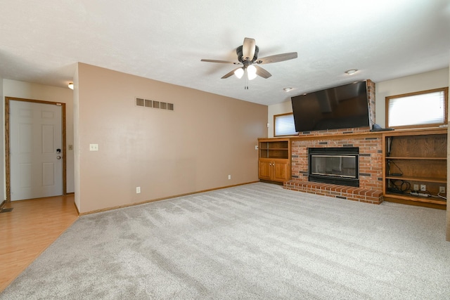 3646 S 77th St, Lincoln, NE 68506 - unfurnished living room with ceiling fan, light colored carpet, and a fireplace