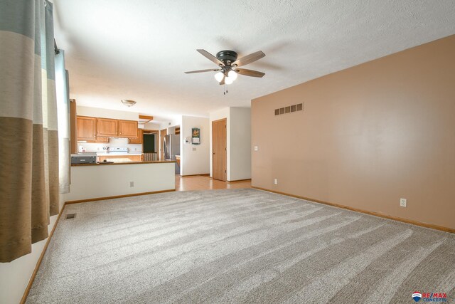 3646 S 77th St, Lincoln, NE 68506 - unfurnished living room with light colored carpet and a ceiling fan