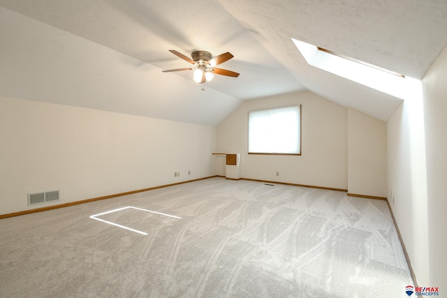 3646 S 77th St, Lincoln, NE 68506 - additional living space featuring ceiling fan, light colored carpet, lofted ceiling, and a skylight