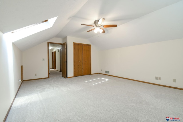 3646 S 77th St, Lincoln, NE 68506 - bonus room with light colored carpet, lofted ceiling, a ceiling fan, and a skylight