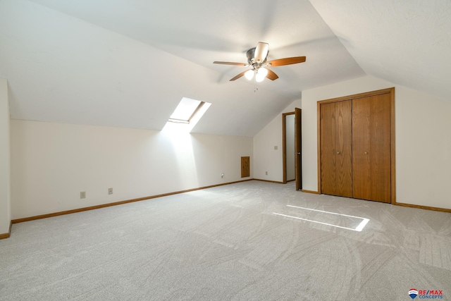 3646 S 77th St, Lincoln, NE 68506 - additional living space featuring ceiling fan, lofted ceiling, light colored carpet, and a skylight