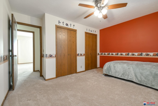 3646 S 77th St, Lincoln, NE 68506 - carpeted bedroom with multiple closets and a ceiling fan