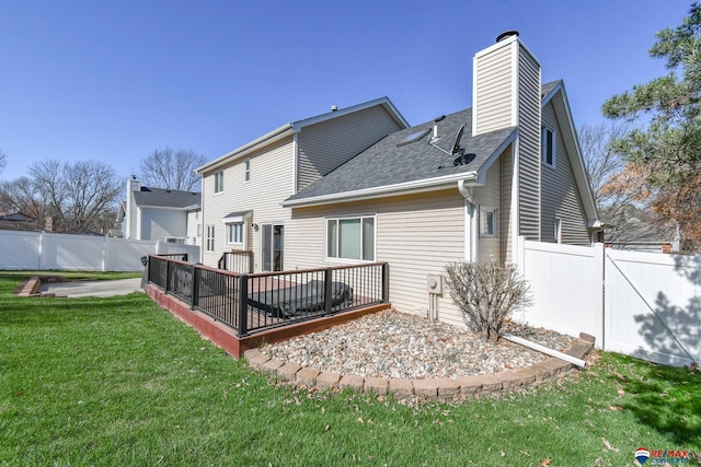 3646 S 77th St, Lincoln, NE 68506 - back of property featuring a deck, a shingled roof, and a chimney