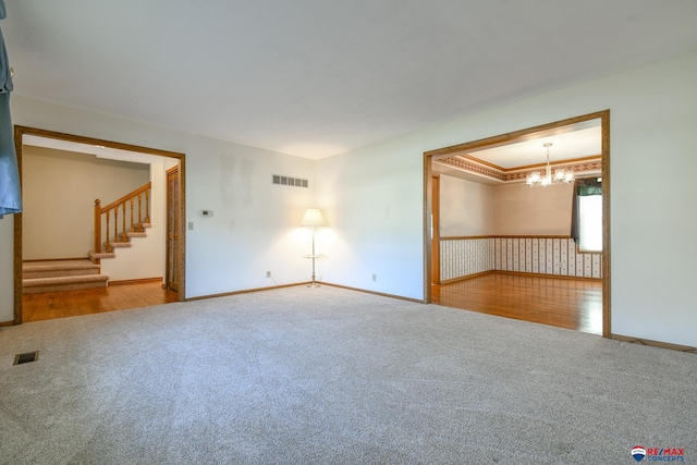 3646 S 77th St, Lincoln, NE 68506 - empty room featuring carpet floors, a chandelier, and stairs