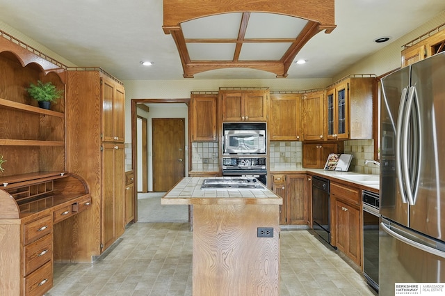 15618 L St, Omaha, NE 68135 - kitchen featuring black appliances, tile countertops, a kitchen island, tasteful backsplash, and recessed lighting
